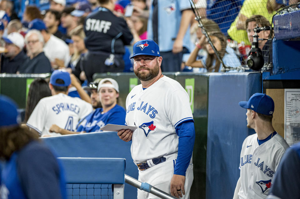 Interim manager John Schneider walks out of the Toronto Blue Jays dugout, before a baseball game against the Philadelphia Phillies, Wednesday, July 13, 2022 in Toronto. (Christopher Katsarov/The Canadian Press via AP)