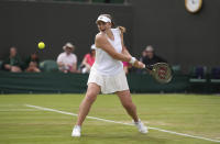 Latvia's Jelena Ostapenko plays a return to Belgium's Yanina Wickmayer in a second round women's singles match on day three of the Wimbledon tennis championships in London, Wednesday June 29, 2022. (AP Photo/Alberto Pezzali)