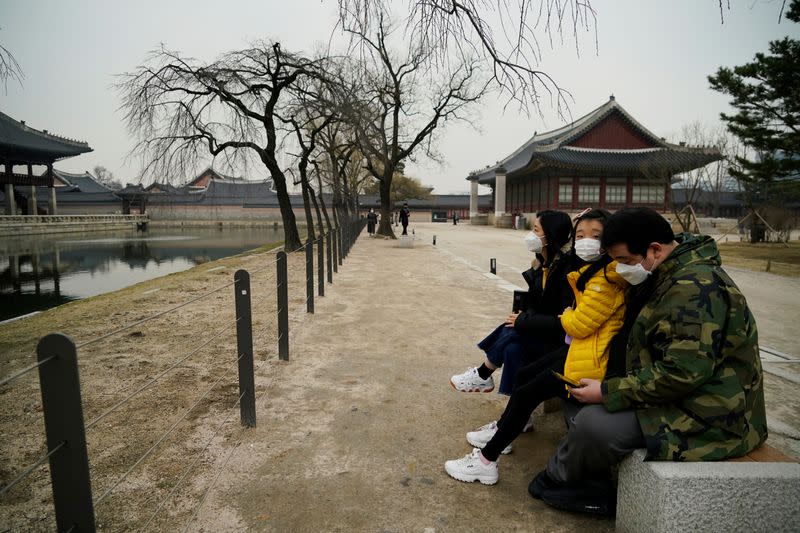A family wearing masks to prevent contacting the coronavirus visits Gyeongbok Palace in central Seoul