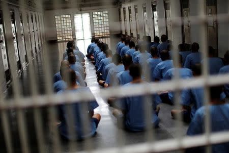 Inmates sit on the floor during an inspection visit in the long term sentence zone inside Klong Prem high-security prison in Bangkok, Thailand July 12, 2016. REUTERS/Jorge Silva