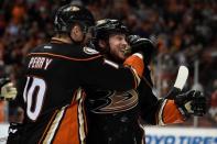 Anaheim Ducks right wing Corey Perry (10) congratulates left wing Matt Beleskey (right) for scoring the game-winning goal against the Chicago Blackhawks during the overtime period in game five of the Western Conference Final of the 2015 Stanley Cup Playoffs at Honda Center. Mandatory Credit: Gary A. Vasquez-USA TODAY Sports