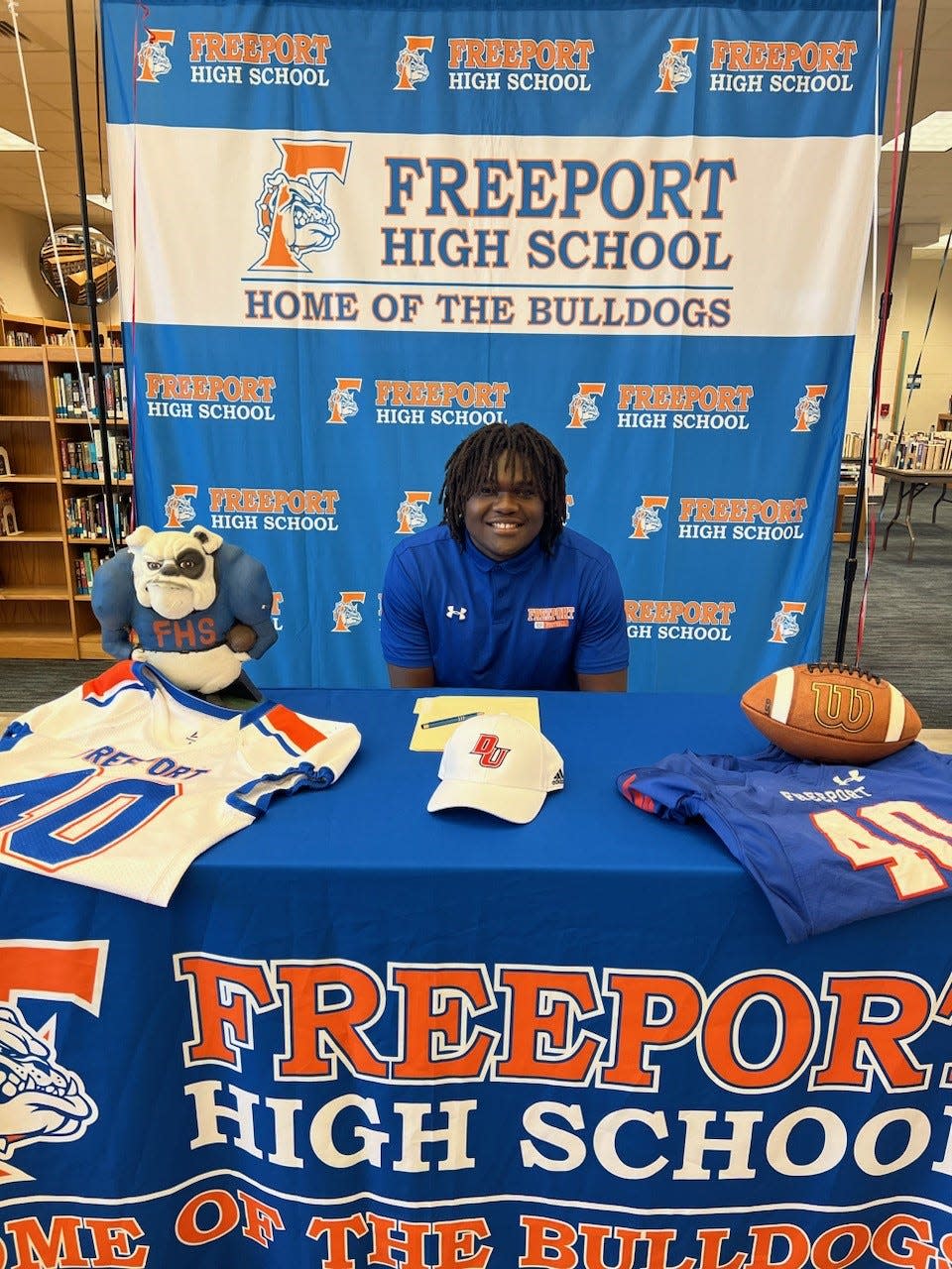 Freeport senior Uriah Frith poses after signing with Davenport University.