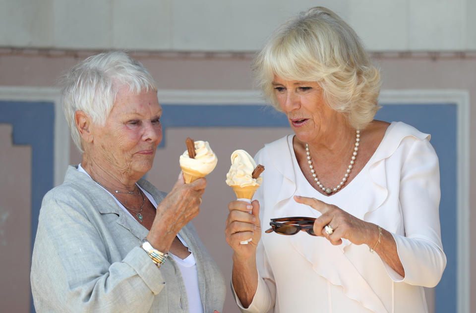 The Duchess of Cornwall enjoys an ice cream with Dame Judi Dench as she arrives at Queen Victoria's private beach, next to the monarch's holiday home in East Cowes on the Isle of Wight. Dame Judi, patron of the Friends of Osborne House, will show Camilla the newly restored Durbar Room, which was one of the locations for the film Victoria and Abdul in which she played Queen Victoria.