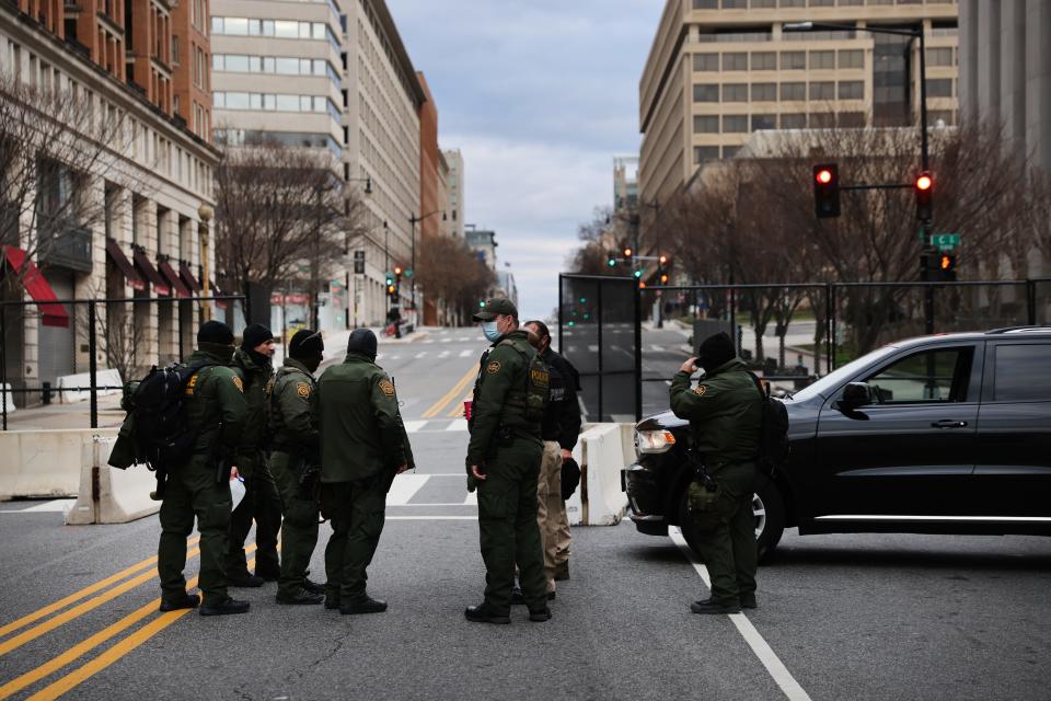 Law enforcement officers stand at a roadblock on Jan. 17, 2021 in Washington, D.C.