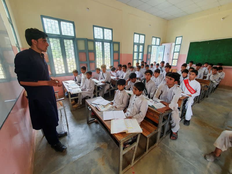 Israr Ahmed, who survived after being rescued from a stranded cable car, sits with other children in a classroom at a school in Battagram