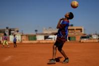 A child with a Messi jersey plays soccer at the neighborhood of Estrutural in Brasilia