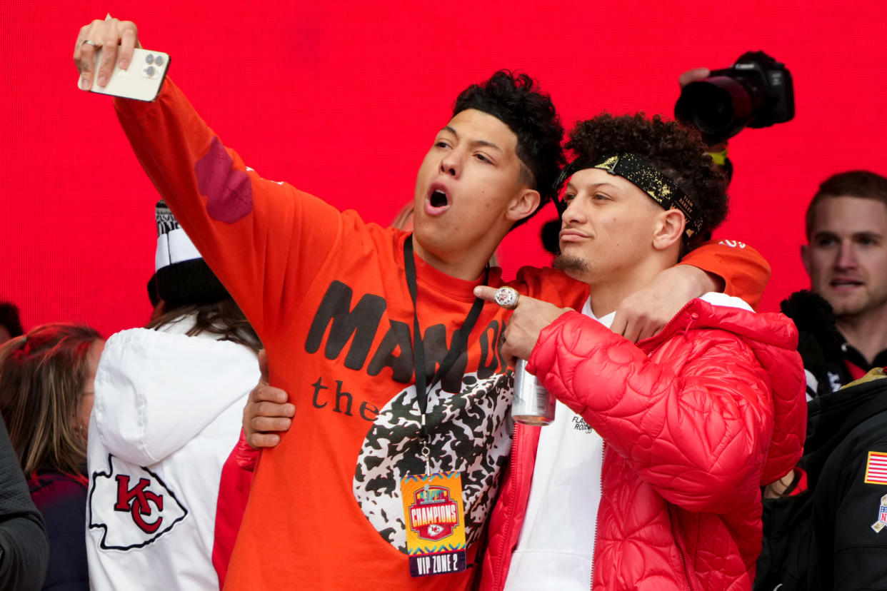 KANSAS CITY, MISSOURI - FEBRUARY 15: Jackson Mahomes and Patrick Mahomes #15 of the Kansas City Chiefs celebrate on stage during the Kansas City Chiefs Super Bowl LVII victory parade on February 15, 2023 in Kansas City, Missouri. (Photo by Jay Biggerstaff/Getty Images)