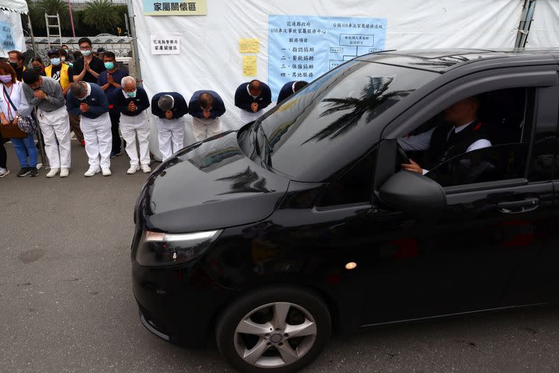 Members of the Tzu Chi Foundation take part in a prayer for the victims of the deadly train derailment, in Hualien