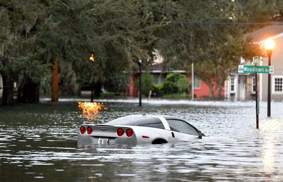 File: A car floating in Hurricane Ian's floodwaters in Orlando.