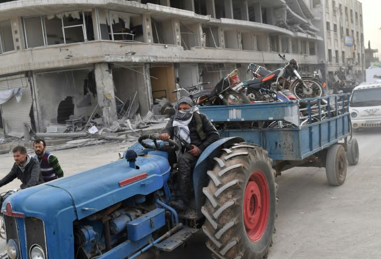 A Turkish-backed Syrian Arab fighter tows towing looted items in a trailer after seizing control of the northwestern Syrian city of Afrin from the Kurdish People's Protection Units (YPG) on March 18, 2018