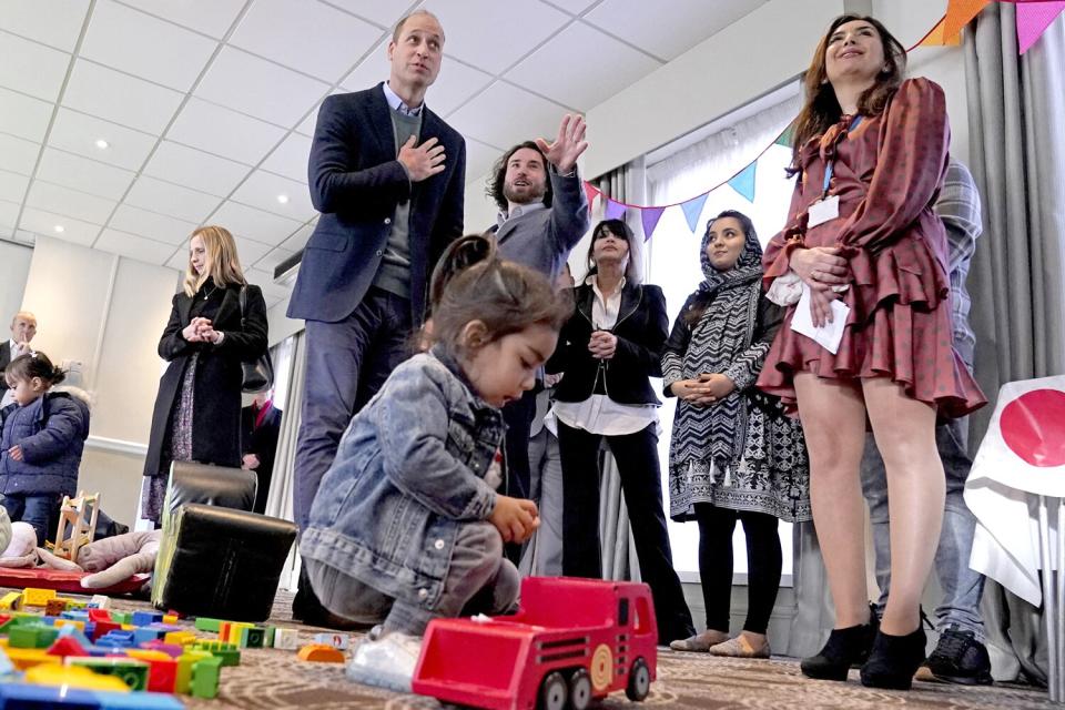 Prince William, Duke of Cambridge with refugees evacuated from Afghanistan during a visit to a hotel in Leeds