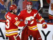 Calgary Flames forward Matthew Tkachuk, right, celebrates his goal against the Edmonton Oilers with forward Johnny Gaudreau during the second period of Game 1 of an NHL hockey second-round playoff series Wednesday, May 18, 2022, in Calgary, Alberta. (Jeff McIntosh/The Canadian Press via AP)