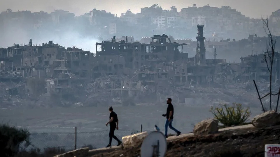 Men walk along the border of Gaza in southern Israel on November 13, 2023. Swathes of the heavily populated enclave has come under relentless Israeli bombardment - Fadel Senna/AFP/Getty Images