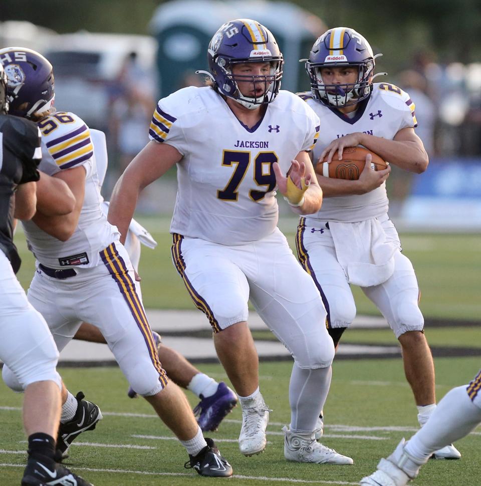 Jackson's Colten Arnold (79) looks to block for teammate Jason Davide (with ball) during a high school football game at Perry on Friday, Sept. 16, 2022.