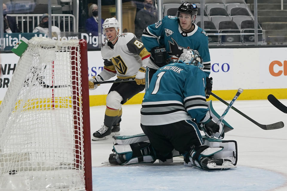 Vegas Golden Knights center Jonathan Marchessault, left, looks toward the goal after scoring past San Jose Sharks goaltender Alexei Melnichuk (1) during the first period of an NHL hockey game in San Jose, Calif., Wednesday, May 12, 2021. (AP Photo/Jeff Chiu)