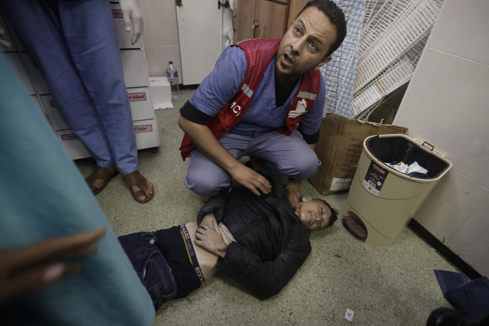 Palestinians wounded in Israeli airstrikes arrive at the Nasser hospital in the town of Khan Younis, southern Gaza Strip, Friday, Dec. 22, 2023. (AP Photo/Mohammed Dahman)