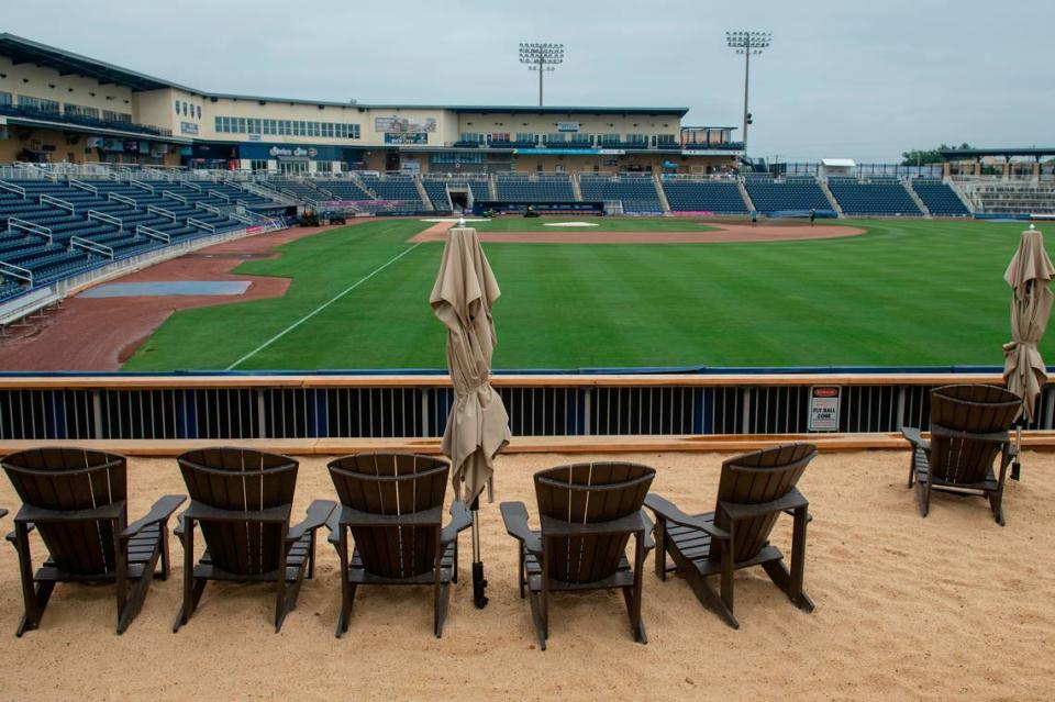 A sandy beach with Adirondack chairs and other additional seating on what was the grassy berm at Shuckers Ballpark on Friday, May 10, 2024.
