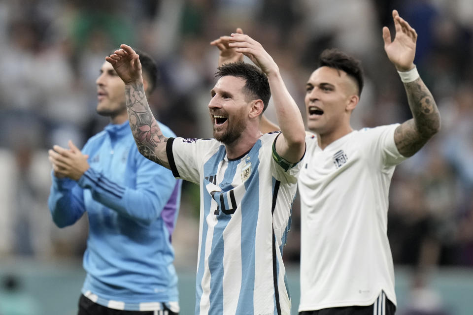 Argentina's Lionel Messi, center, celebrates at the end of the World Cup group C soccer match between Argentina and Mexico, at the Lusail Stadium in Lusail, Qatar, Saturday, Nov. 26, 2022. Argentina won 2-0. (AP Photo/Moises Castillo)