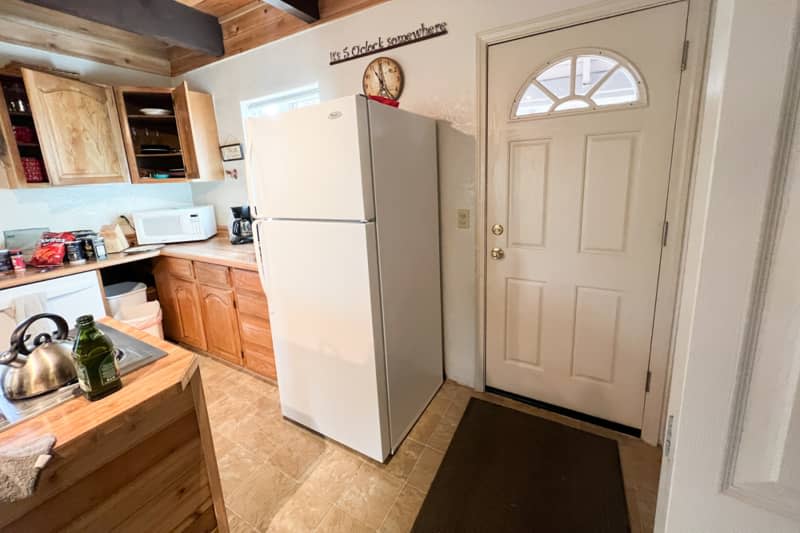 Refrigerator in kitchen before renovation.