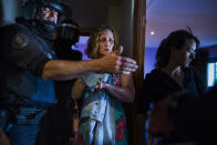 <p>Carmen Rives, 50, gestures as riot police enter her apartment to evict her, Madrid, June 2, 2015. (AP Photo/Andres Kudacki) </p>