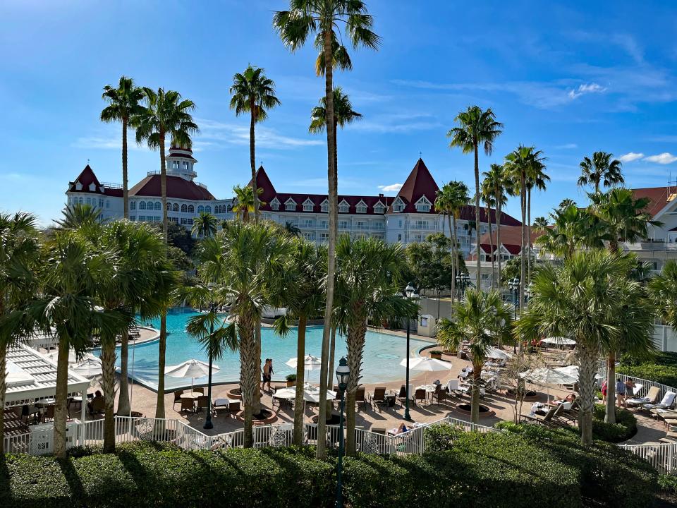 view of the grand floridian main lobby building a pool from the patio of a hotel room