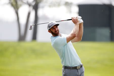 FILE PHOTO - Sep 14, 2017; Lake Forest, IL, USA; PGA golfer Dustin Johnson hits his approach shot on the first hole during the first round of the BMW Championship golf tournament at Conway Farms Golf Club. Mandatory Credit: Brian Spurlock-USA TODAY Sports