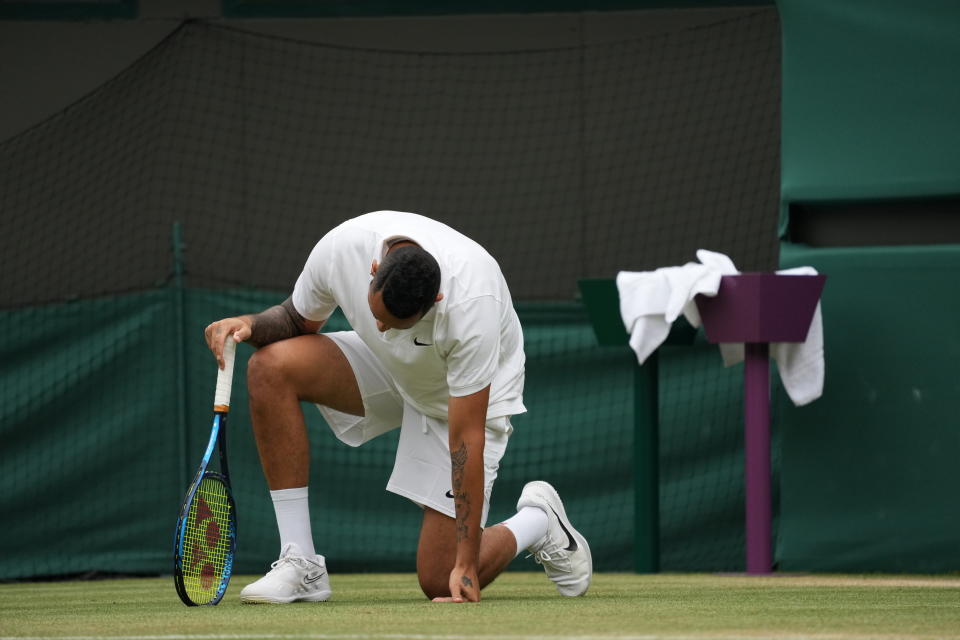 Australia's Nick Kyrgios falls during the men's singles third round match against Canada's Felix Auger-Aliassime on day six of the Wimbledon Tennis Championships in London, Saturday July 3, 2021. (AP Photo/Alberto Pezzali)