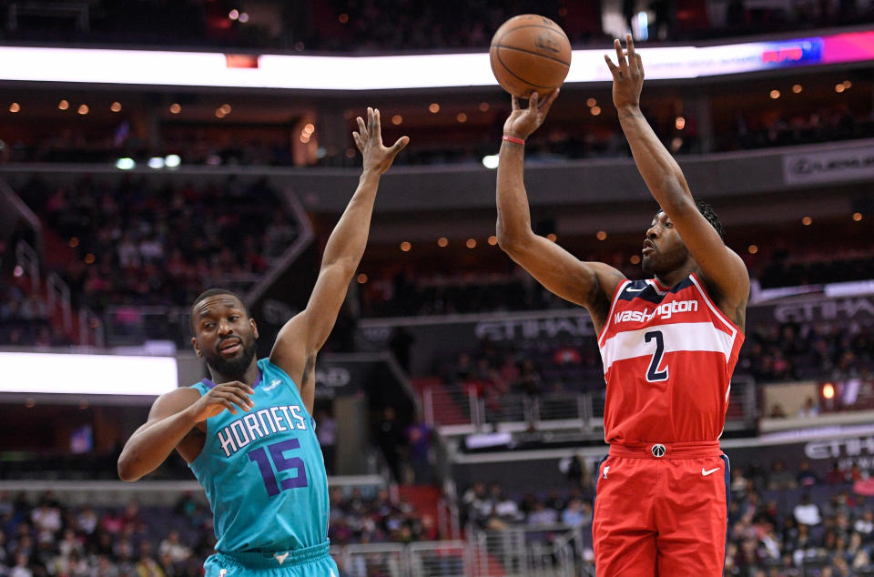 Wizards guard John Wall shoots over Hornets guard Kemba Walker on Saturday. (AP)