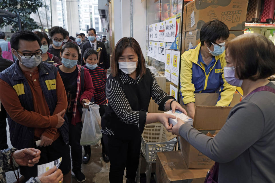 FILE - In this Feb. 7, 2020, file photo, people queue up to buy face masks in Hong Kong. Fear of the spreading coronavirus has led to a global run on sales of face masks despite medical experts' advice that most people who aren't sick don't need to wear them. (AP Photo/Kin Cheung, File)