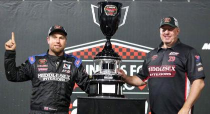 Jon McKennedy, left, driver of the No. 79 Middlesex Interiors Modified, celebrates after winning the 2022 NASCAR Whelen Modified Tour championship at Martinsville Speedway on October 27, 2022.