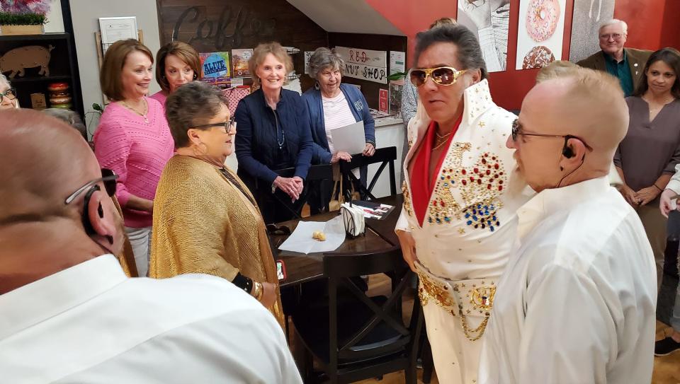 Elvis, played by Tim LeBeau, walks into Red Donut Shop during filming to reenact the King of Rock 'N' Roll's 1956 performance in Lexington. Virginia Weisner, (standing to the right behind a chair) was at the 1956 concert to see the real Elvis perform. She was only 16.