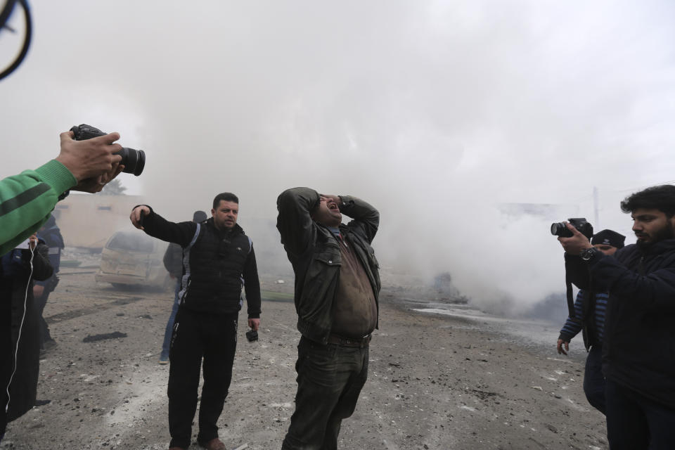 A man wails after a government airstrike in the city of Idlib, Syria, Tuesday, Feb. 11, 2020. The latest violence in Idlib came as government forces came closer to capturing the last rebel-held part of a strategic highway linking southern and northern Syria, which would bring the road under Syrian President Bashar Assad's full control for the first time since 2012. (AP Photo/Ghaith Alsayed)