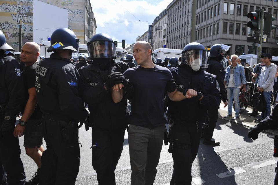 Police clearing a street during a demonstration against the Corona measures in Berlin, Germany, Saturday, Aug. 29, 2020. (Bernd Von Jutrczenka/dpa via AP)