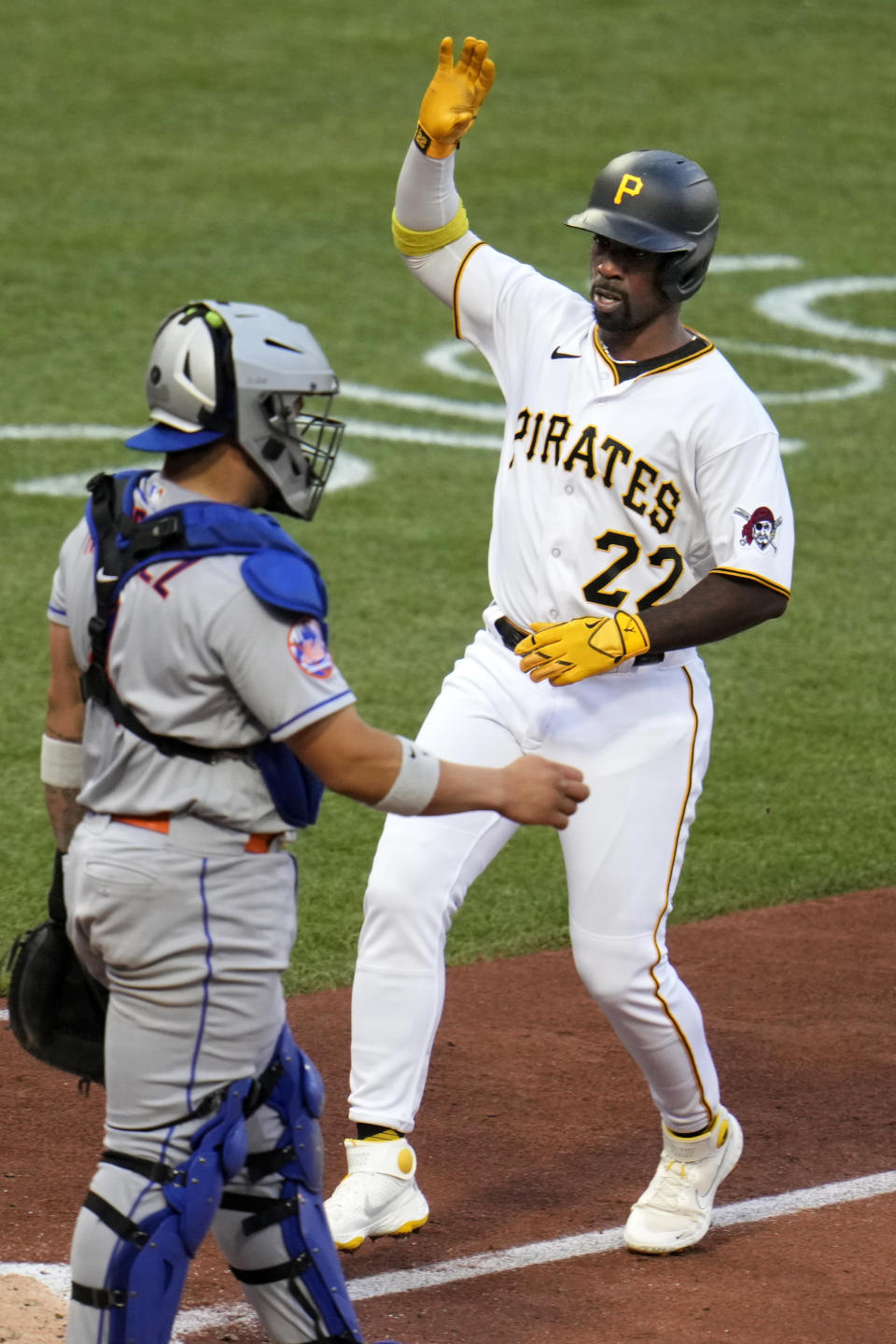 Pittsburgh Pirates' Andrew McCutchen (22) scores one of two runs on a single by Pittsburgh Pirates' Ke'Bryan Hayes off New York Mets starting pitcher Tylor Megill during the third inning of a baseball game in Pittsburgh, Friday, June 9, 2023. (AP Photo/Gene J. Puskar)