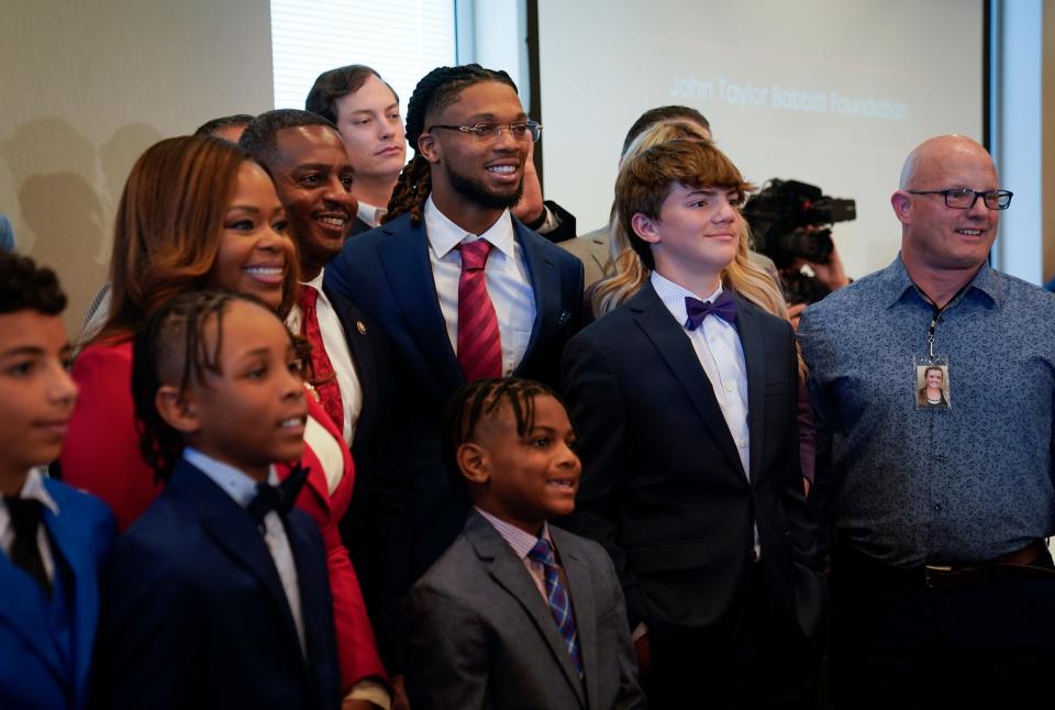 Rep. Sheila Cherfilus-McCormick, D-Fla., middle left, along with Buffalo Bills safety Damar Hamlin, center, at an event sponsored by Cherfilus-McCormick in Washington, D.C. on March 29, 2023. Following Damar Hamlin's collapse, Cherfilus-McCormick saw the story of Matthew Mangine Jr., a Northern Kentucky athlete who died after he didn't receive a shock from an AED for more than 12 minutes at soccer conditioning. She began drafting legislation to help provide money to schools without AEDs.