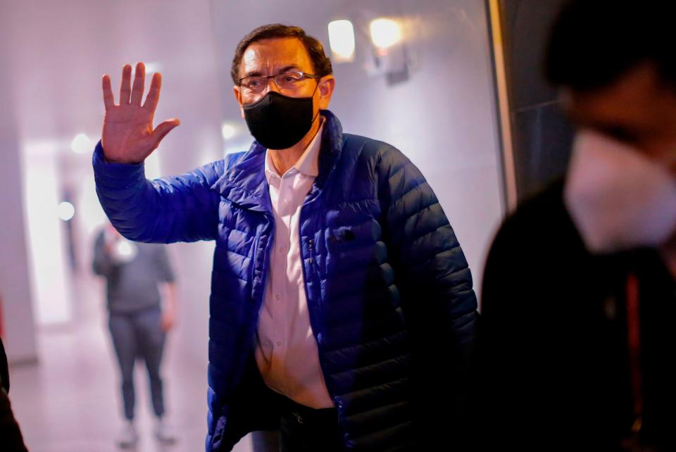 <p>Former Peruvian President Martin Vizcarra waves to the press upon his arrival home after leaving the Presidential Palace in Lima, following his impeachment by an overwhelming majority Congress vote</p>AFP via Getty Images