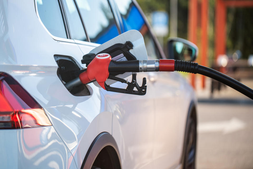 Refuelling car at the gas station, illustrating a piece on the best credit cards for petrol in Singapore (2024).