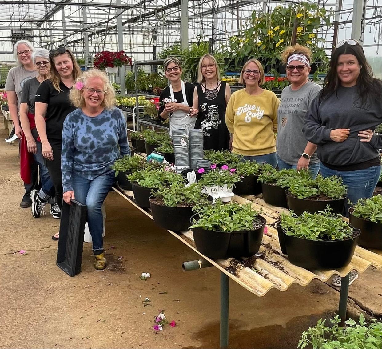 Those involved in the Newcomerstown Now hanging baskets project are ‒ Left front to back: 
Brenda Junkin, master gardener, Heather Mann, AnneMarie Maddox and Carrie Kunkle; Right front to back: Jessica Moore, Lisa Spillman, Jen LaVigne, Susie Hart and Nancy Orr.