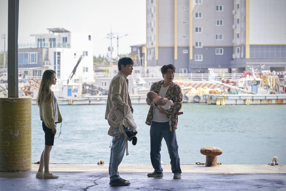 This image provided by Neon shows IU, from left, Gang Dong-won and Song Kang-ho in a scene from "Broker." (Neon via AP)