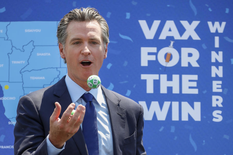 Universal City, CA - June 15: As part of California's full reopening, marking the end of pandemic-era restrictions like masks, social distancing and most capacity restrictions, Gov. Gavin Newsom juggles numbered balls following the conclusion of a press conference at Universal Studios, in Universal City, CA, Tuesday, June 15, 2021. Governor Newsom drew 10 winners to receive $1.5 million each, for a total of $15 million, as part of the final cash prize drawing in the state's $116.5 million Vax for the Win program - the largest vaccine incentive program in the nation. (Jay L. Clendenin / Los Angeles Times via Getty Images)