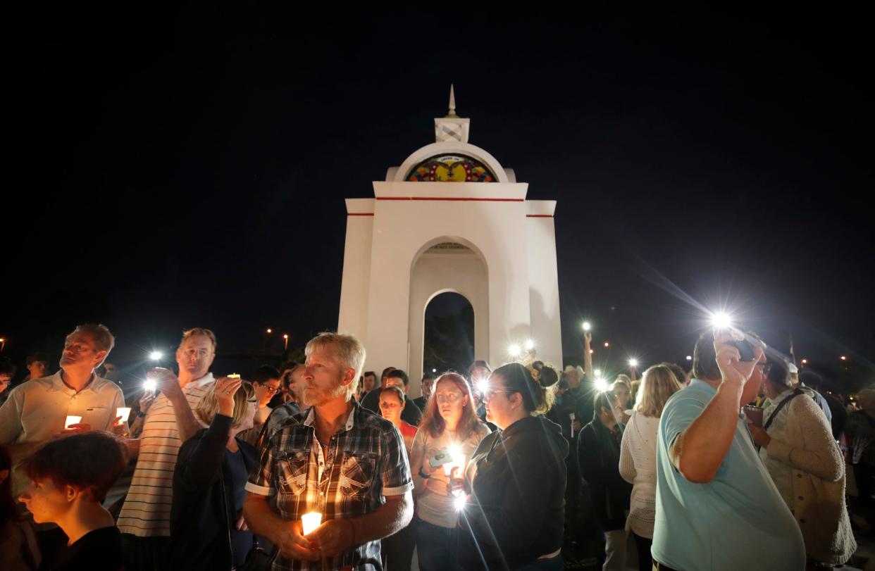 Friends and classmates light candles and lights on their phones during memorial at the Brannon Center for a New Smyrna Beach High School student who was killed in a car accident last weekend in New Smyrna Beach.