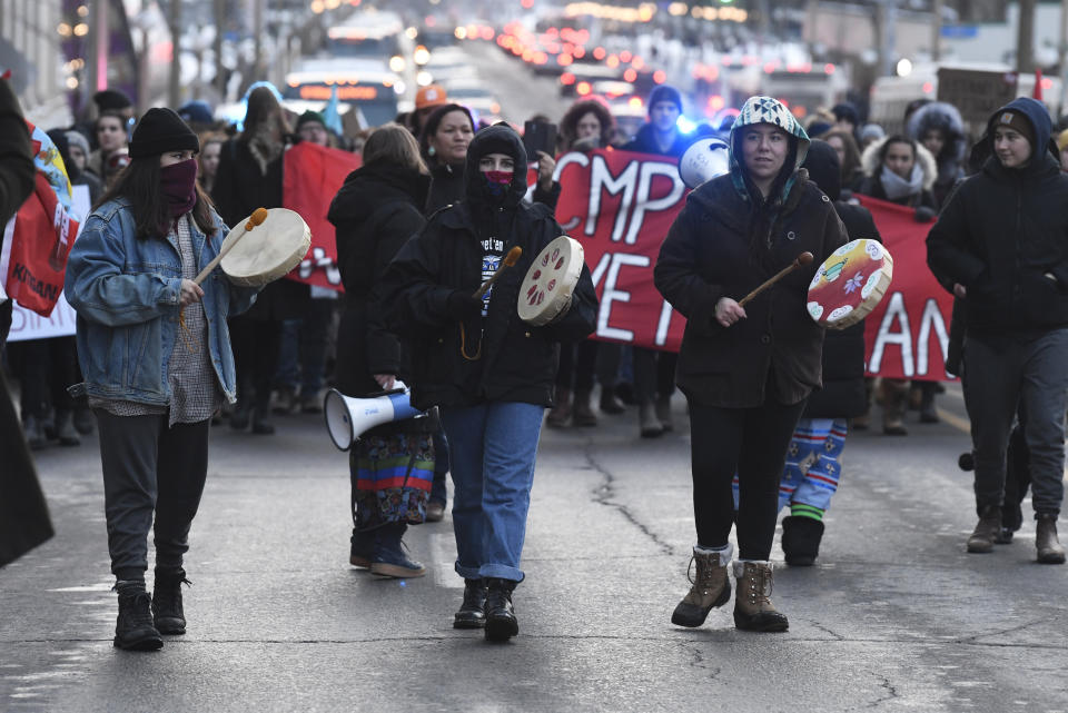 Protesters march on a street in Ottawa, Ontario, Wednesday, Feb. 12, 2020. The protesters are standing in solidarity with the Wet'suwet'en hereditary chiefs opposed to a Canada gas pipeline in northern British Columbia. (Adrian Wyld/The Canadian Press via AP)