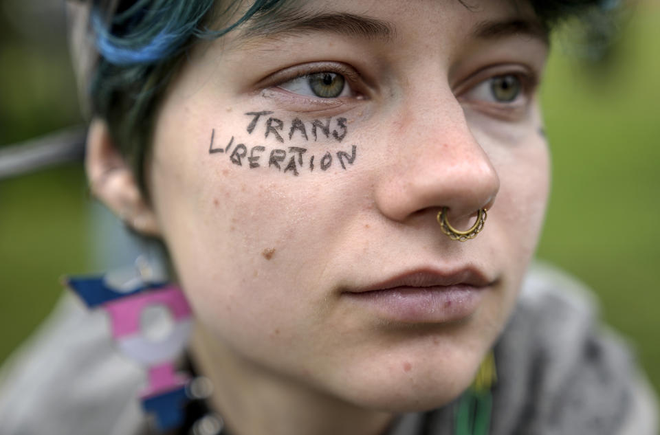 A Demonstrator protests demanding a law to protect the rights of the transgender community outside of the parliament Bundestag building in Berlin, Friday, Apri 12, 2024. German lawmakers on Friday approved legislation that will make it easier for transgender, intersex and nonbinary people to change their name and gender in official records. (AP Photo/Ebrahim Noroozi)