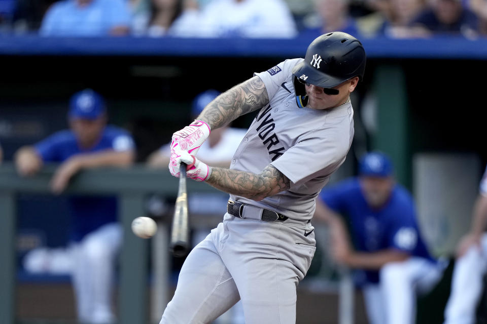 New York Yankees' Alex Verdugo hits a two-run single during the first inning of a baseball game against the Kansas City Royals Wednesday, June 12, 2024, in Kansas City, Mo. (AP Photo/Charlie Riedel)