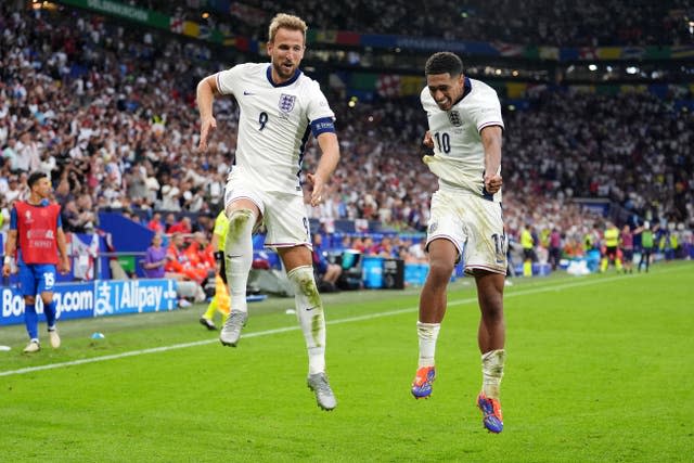 Harry Kane and Jude Bellingham jump in the air to celebrate Kane's goal against Slovakia