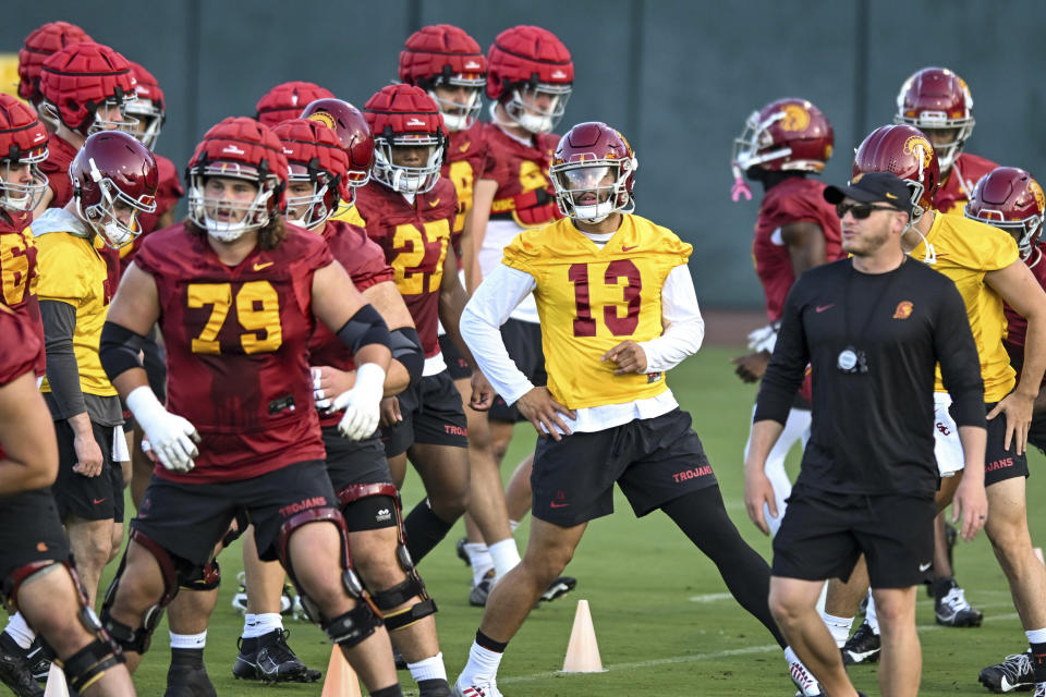 Southern California quarterback Caleb Williams (13) and teammates are shown during an NCAA college football practice in Los Angeles, Friday, July 28, 2023. (David Crane/The Orange County Register via AP)