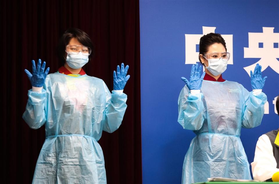 EVA Air (left) and China Airlines (right) flight attendants pose at press conference donning their new protective gear. (Courtesy of the CECC)