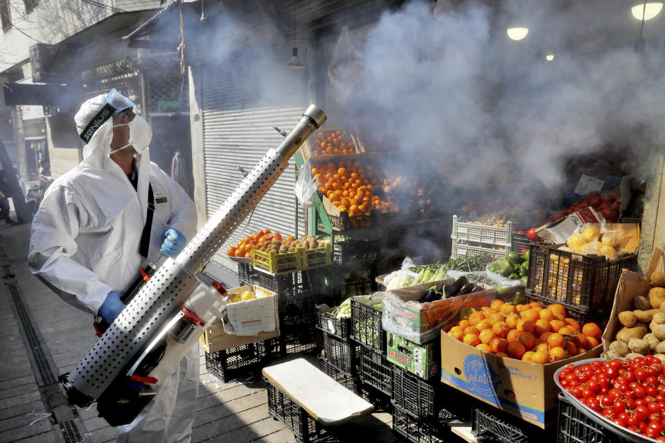 A firefighter disinfects a traditional shopping center to help prevent the spread of the new coronavirus in northern Tehran, Iran, Friday, March, 6, 2020. A Health Ministry spokesman warned authorities could use unspecified “force” to halt travel between major cities. (AP Photo/Ebrahim Noroozi)