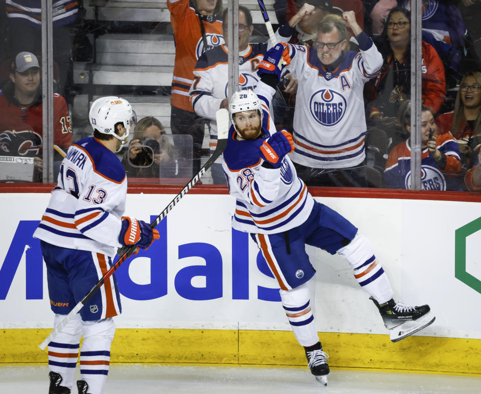 Edmonton Oilers forward Connor Brown (28) celebrates his goal against the Calgary Flames with forward Mattias Janmark (13) during the second period of an NHL hockey game Saturday, April 6, 2024, in Calgary, Alberta. (Jeff McIntosh/The Canadian Press via AP)