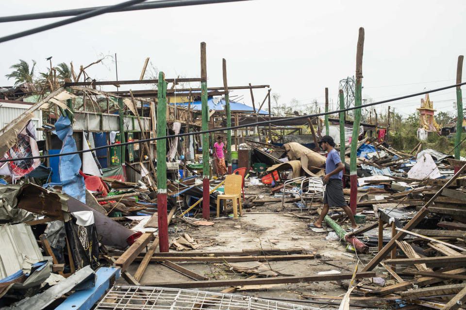 Local residents walk past damaged buildings after Cyclone Mocha in Sittwe township, Rakhine State, Myanmar, Tuesday, May 16, 2023. Myanmar’s military information office said the storm had damaged houses and electrical transformers in Sittwe, Kyaukpyu, and Gwa townships. (AP Photo)